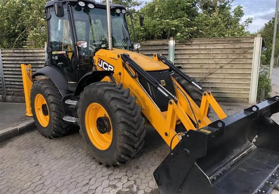 بکهو لودر JCB 4CX در حال بارگیری مواد در یک سایت عمرانی