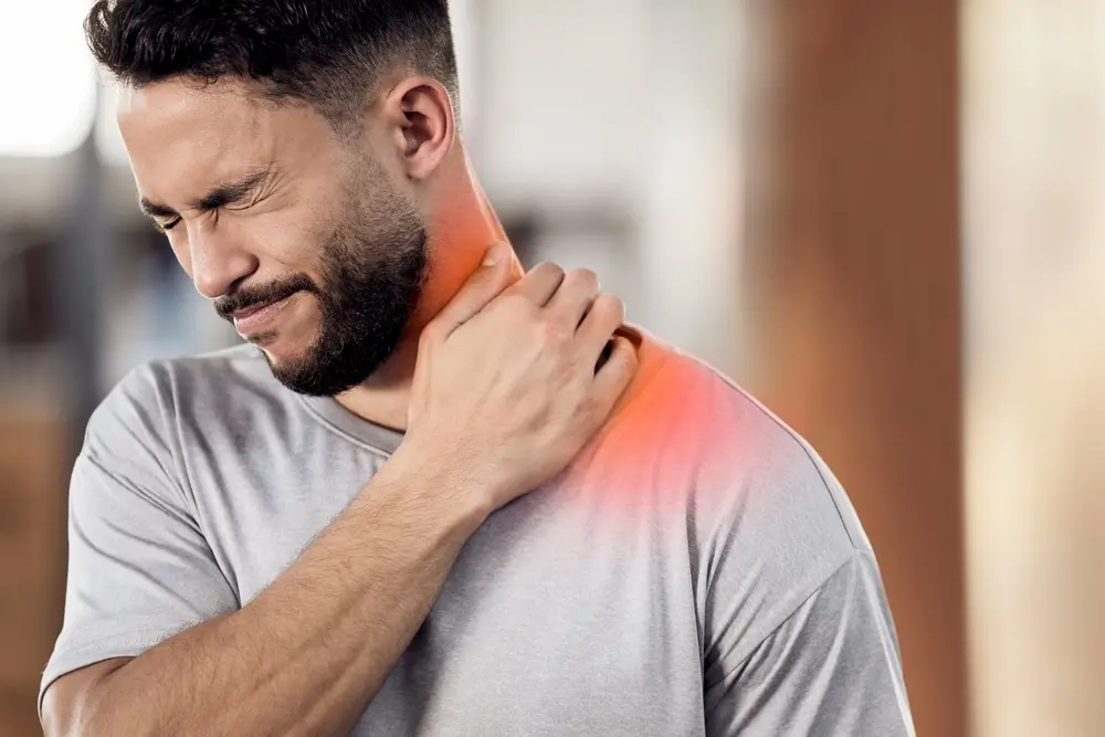 یک فرد در حال استفاده از کمپرس گرم برای کاهش درد گردن
